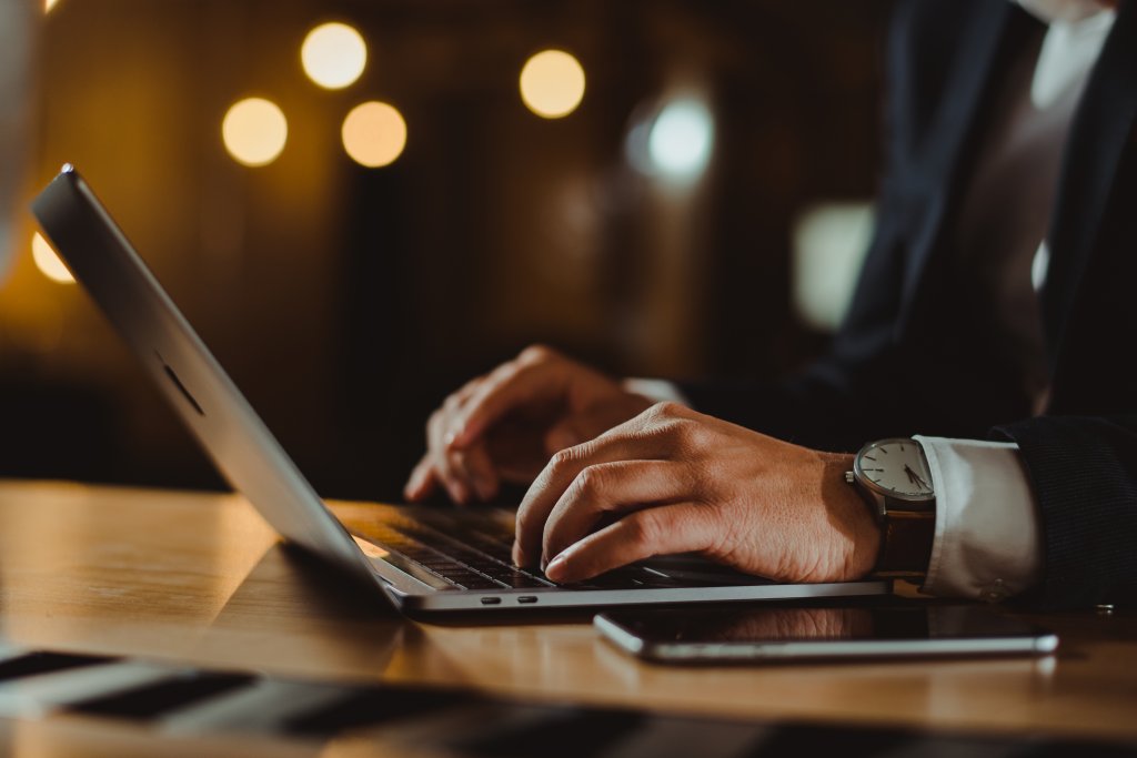 A person typing on a laptop