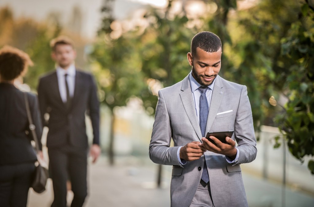 A man reading a security advisory on a tablet